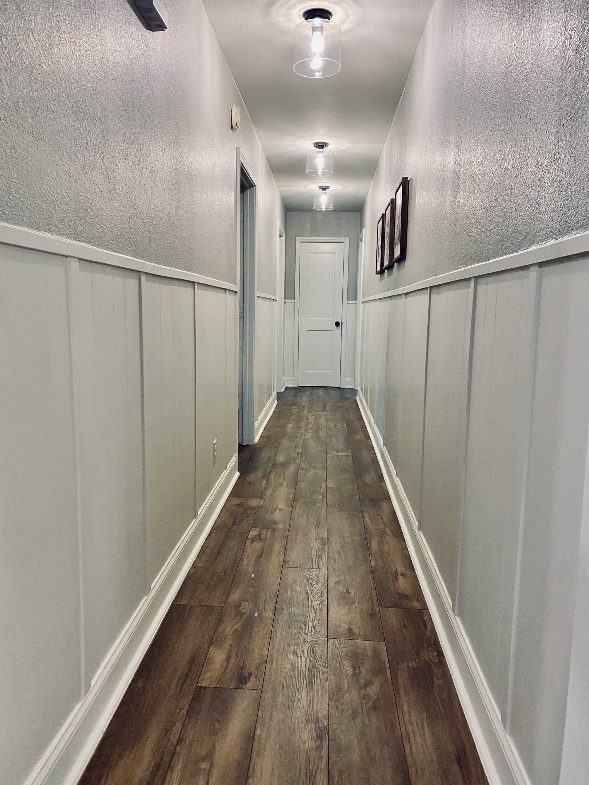 hallway, before and after, diy, painted paneling, farmhouse, shiplap, wood floors